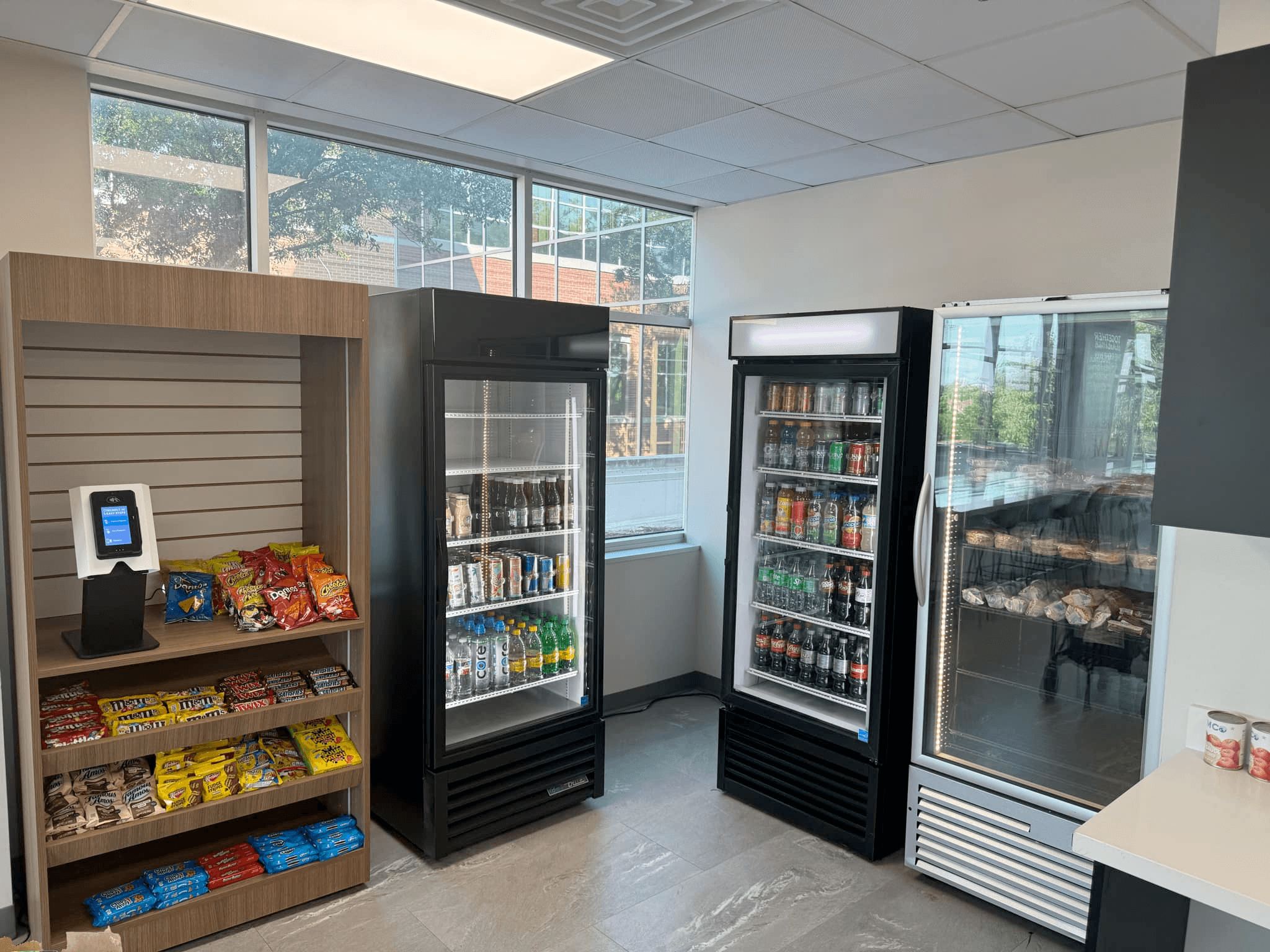 Employee using a fresh food vending fridge in an office